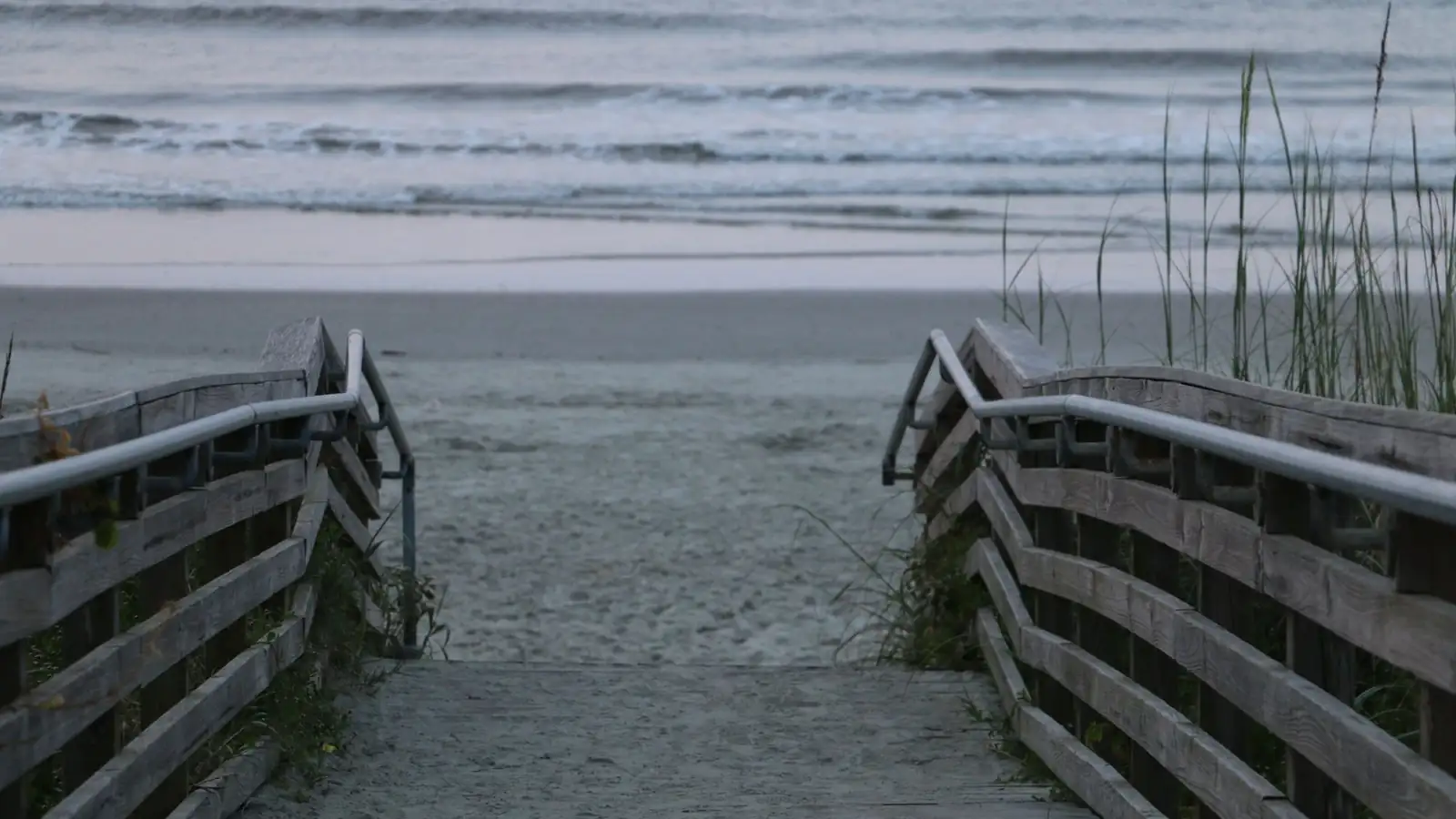 Wooden boardwalk path leading to an ocean beach